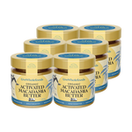 Six jars of Live Whole Foods Organic Activated Macadamia Butter arranged in two rows on a plain white background.