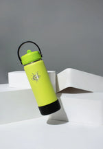 Lime green Cheeki 750ml bottle shown falling to demonstrate its durable, impact-resistant stainless steel design.