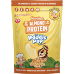 A 400g stand-up pouch of Macromike Paddle Pop Banana Protein powder, featuring a bright yellow and orange design with cartoon illustrations of a banana and a lion.