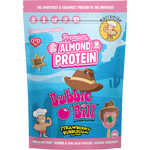 A 400g bag of Macromike x Bubble O' Bill Premium Almond Protein in Strawberry Bubblegum flavor. The packaging features a bright blue desert landscape background with pink and white text, cartoon illustrations of characters, and a brown cowboy hat graphic.