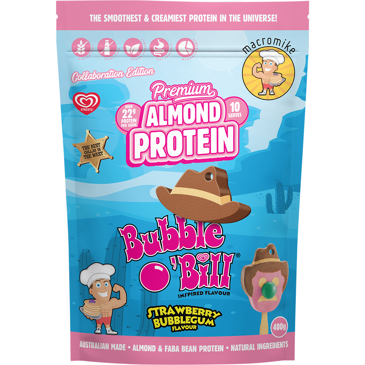 A 400g bag of Macromike x Bubble O' Bill Premium Almond Protein in Strawberry Bubblegum flavor. The packaging features a bright blue desert landscape background with pink and white text, cartoon illustrations of characters, and a brown cowboy hat graphic.