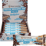 A display box and individual wrapped protein indulgence bar from macromike, Cookie & Cream flavor, on a plain white background.