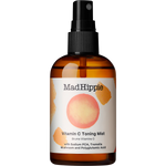 Mad Hippie Vitamin C Toning Mist in an amber glass spray bottle with a black pump dispenser and a white label featuring a pinkish-orange circle graphic.
