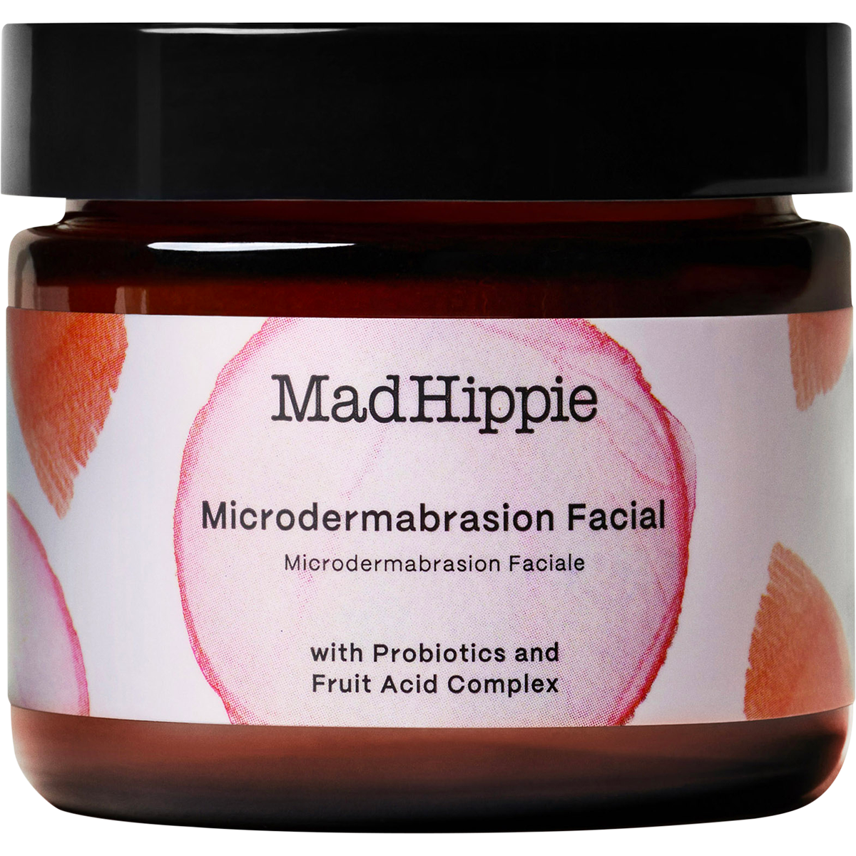 Mad Hippie Microdermbasation Facial jar in an amber glass bottle with a black lid and a white label featuring pink circular graphics.
