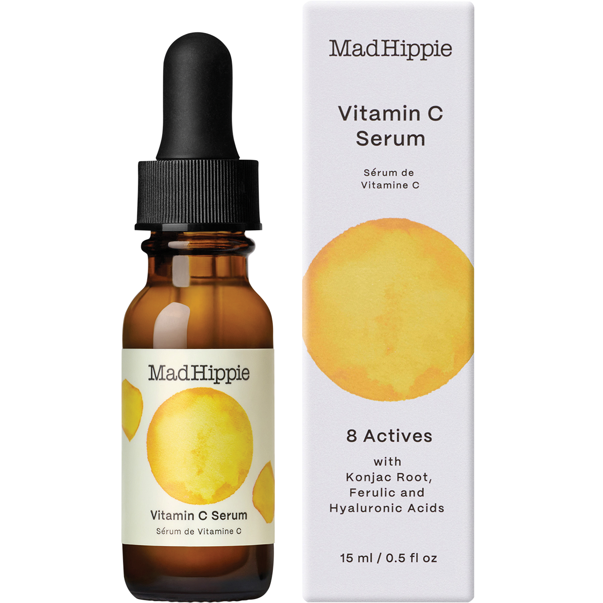 Mad Hippie Vitamin C Serum in an amber glass dropper bottle next to its white cardboard packaging box, both featuring a yellow watercolor circle graphic.