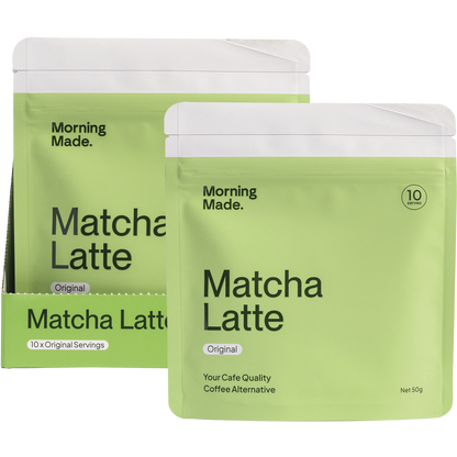 Morning Made Original Matcha Latte bag and box next to a prepared matcha drink with a bamboo whisk and bowl.