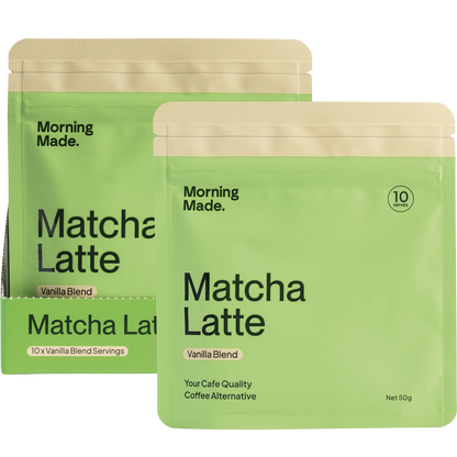Vanilla Matcha Latte box, sachet, and a frothy green drink in a glass with a gold spoon on a white background.