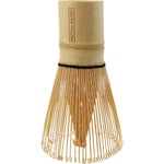 Matcha Maiden bamboo matcha whisk shown from the back in its clear plastic cylindrical packaging.