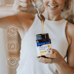 Close-up of the black and gold lid on a jar of Natural Life Manuka Honey MGO 550 against a white background.