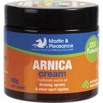 100g jar of Martin & Pleasance Arnica Herbal Cream for bruising and sprains, featuring yellow arnica flower illustrations.