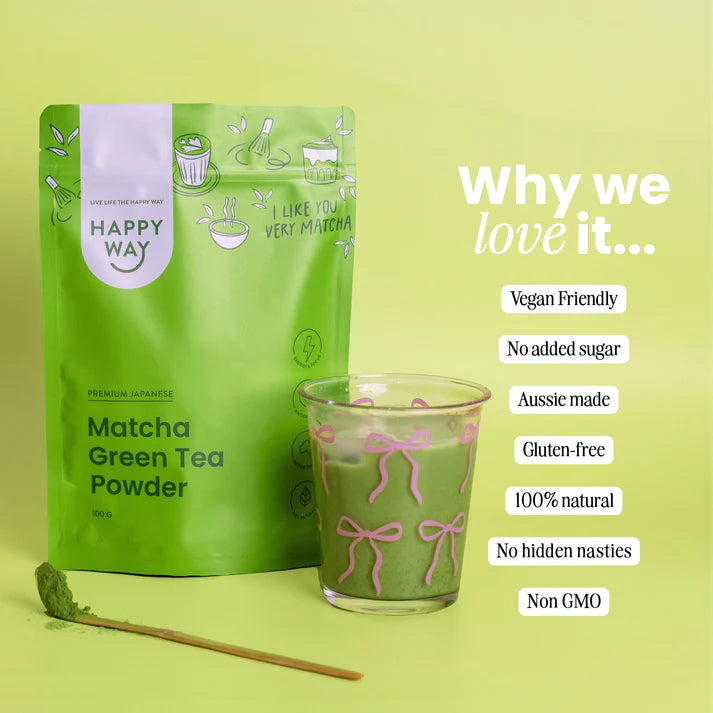 A wooden bowl of vibrant green matcha powder with a traditional bamboo whisk and a cup of prepared matcha tea.