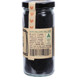 Side view of a 120g glass jar of Mindful Foods Organic Black Cumin seeds with a brown and white label.