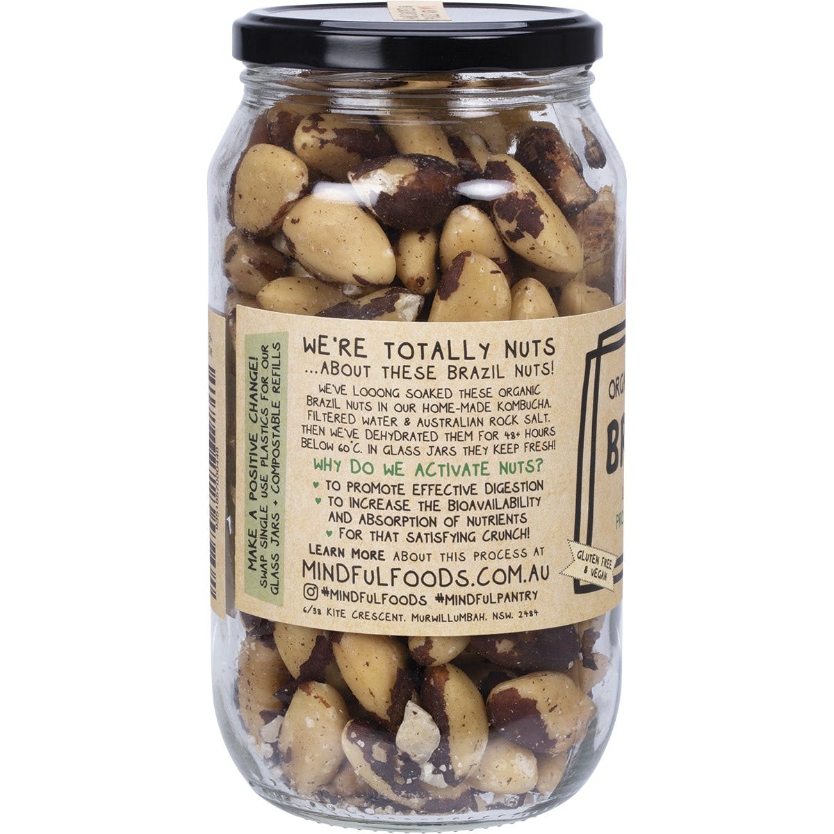 Large glass jar of Mindful Foods organic activated Brazil nuts with a blue and white label on a white background.
