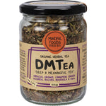 Mindful Foods DMTea 100g glass jar with orange label, featuring organic herbal ingredients like cinnamon and star anise.
