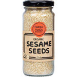 140g glass jar of Mindful Foods Organic Sesame Seeds with a white and gold label on a white background.