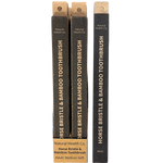 Three black horse bristle and bamboo toothbrush sticks with gold lettering, shown against a plain white background. The brand 'Natural Health Co.