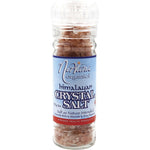 Nirvana Organics 125g glass grinder filled with pink Himalayan salt granules on a white background.