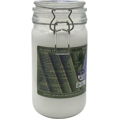 1L glass jar of Niugini Organics Virgin Coconut Oil with a white label and clip-top lid on a white background.