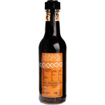 Side view of a Niulife Coconut Sweet Chilli Sauce 250ml bottle showing product features and organic certification.