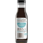 Bottle of Niulife Organic Extra Thick Naked Coconut Amino Sauce with a gold label on a white background.