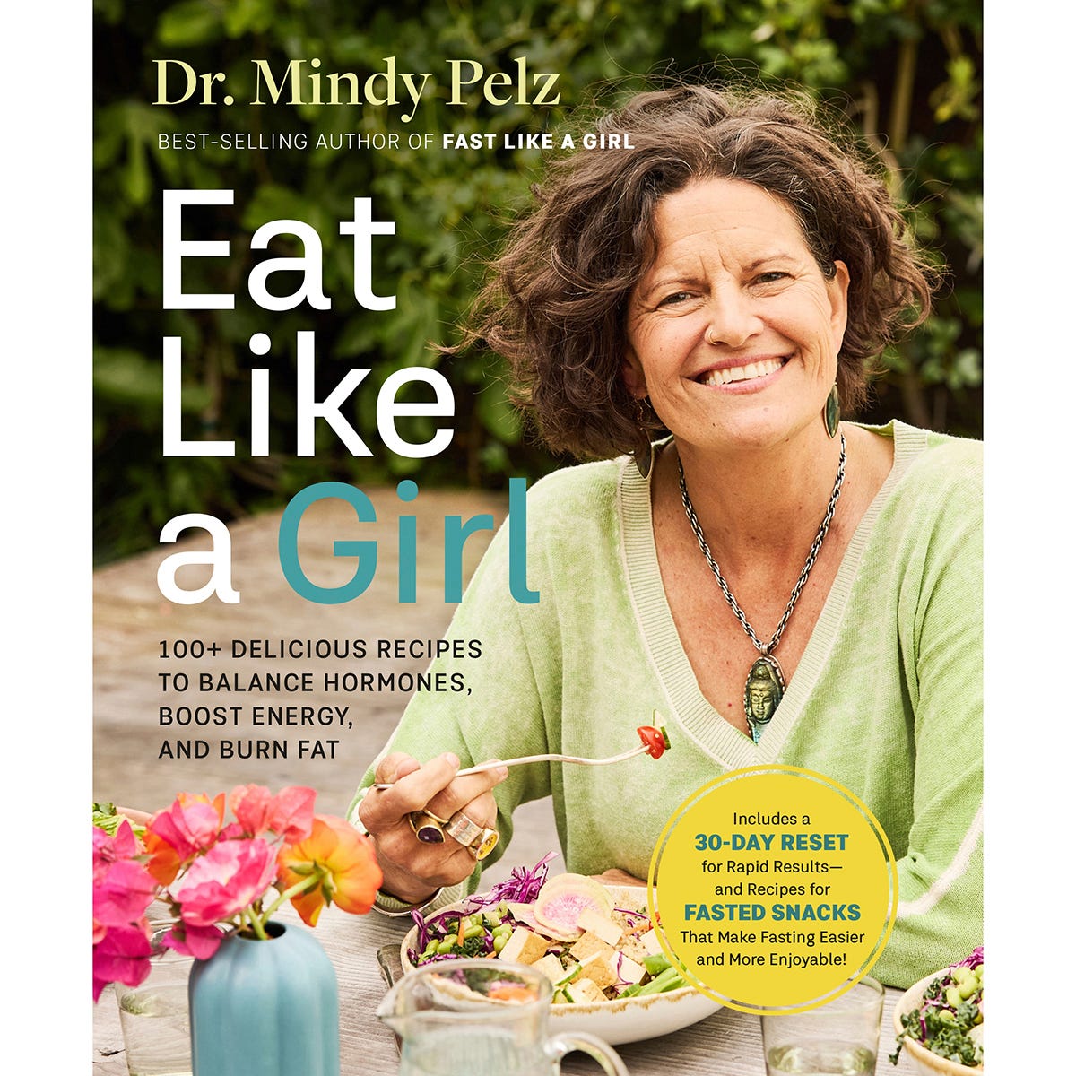 Book cover of Eat Like a Girl by Dr. Mindy Pelz, featuring a vibrant floral design on a white background.
