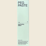 Front of Peg Paste Natural Mint toothpaste box featuring a white design, mint leaf illustration, and 100g weight.