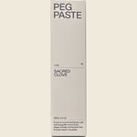Front of a Peg Paste Sacred Clove toothpaste box featuring botanical illustrations on a white background.