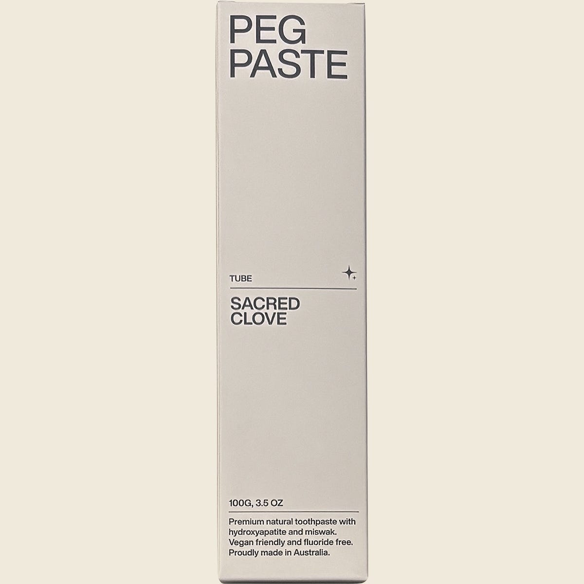 Front of a Peg Paste Sacred Clove toothpaste box featuring botanical illustrations on a white background.