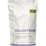 A white stand-up pouch of Protein Australia Colostrum grass-fed pasture raised, featuring a yellow brand logo and purple text on a clean white background.