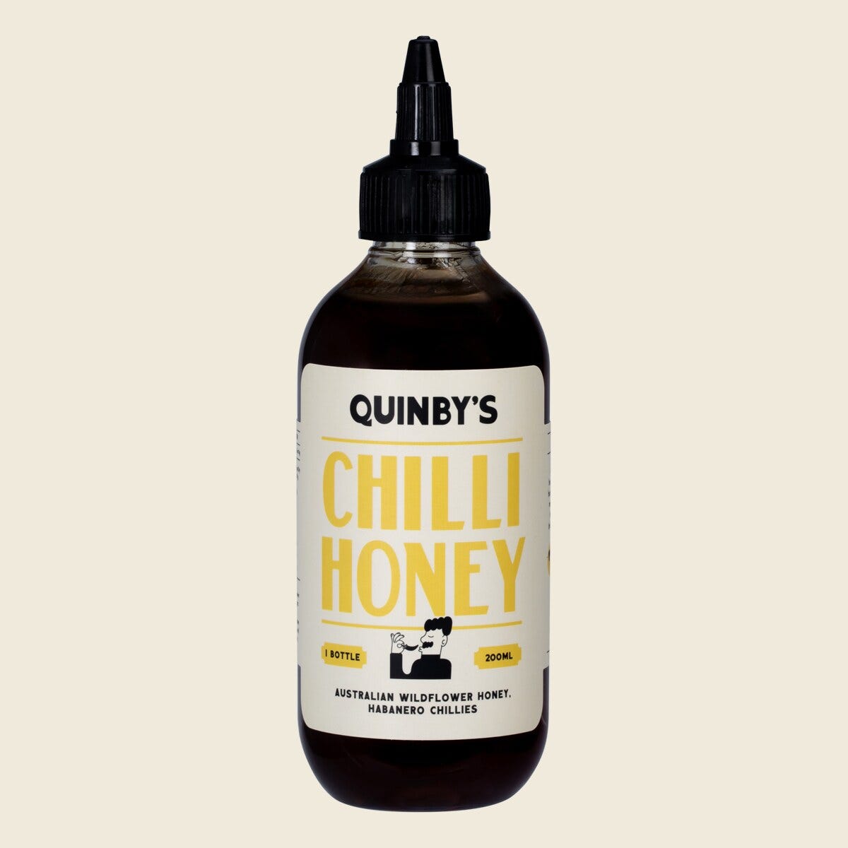 200ml bottle of Quinbys Chilli Hot Honey with a yellow label and red cap on a white background.