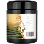 A black plastic jar of SuperElast hair-building hair powder, featuring a white label with a scenic green tea plantation graphic and product details.