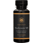 90 capsules of SuperFeast Mushroom M8 in a dark violet glass jar with a black lid and gold and white labeling.