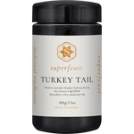 SuperFeast Turkey Tail 100g amber glass jar with a black lid and white label featuring botanical mushroom illustrations.