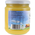 A glass jar of butter with a white lid, showing the back label with nutritional information, ingredients, and a cow illustration. The butter inside is pale yellow.