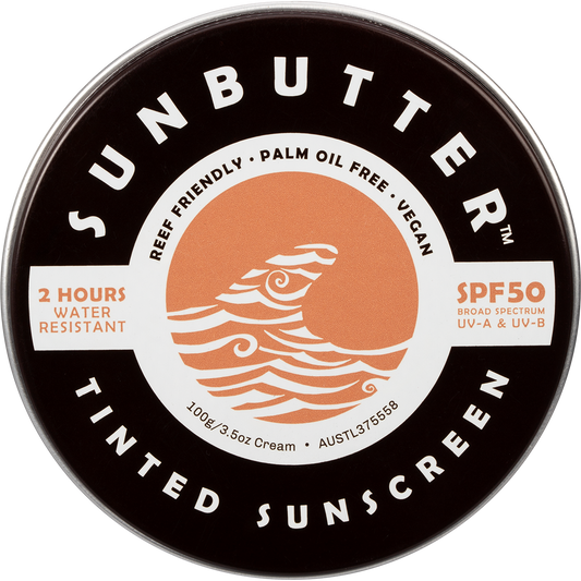 SunButter SPF50 Tinted Sunscreen in a 100g plastic-free tin with a sunset and ocean design.