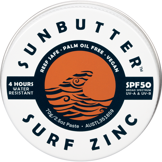 70g tin of SunButter SPF50 Surf Zinc with a tan-colored label featuring a wave design and plastic-free packaging.