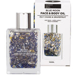 Summer Salt Body Blue Moon face and body oil bottle with 24K gold flakes and blue crystals next to its gift box.
