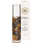 Summer Salt Body 24K Gold Strength essential oil roller and box featuring Tiger Eye crystals and orange botanical design.