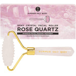 Rose quartz spiky facial roller with a matching pink storage pouch and a luxe white gift box.