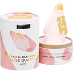 Pink Rose Quartz Jasmine bath bomb inside an open pink and white floral box on a white background.