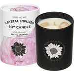 Rose Quartz infused soy candle with a Salted Caramel scent, featuring two pink gemstones and a floral label.