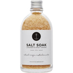 Glass jar of Summer Salt Body Lavender and Sweet Orange salt soak with a white label and a wooden spoon on the side.