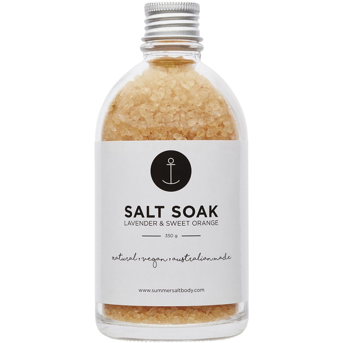Glass jar of Summer Salt Body Lavender and Sweet Orange salt soak with a white label and a wooden spoon on the side.