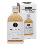 Lavender and Sweet Orange salt soak in a 350g pouch and glass jar, featuring botanical labels and a wooden spoon.