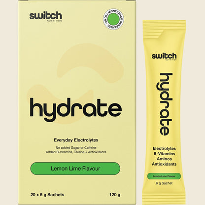 Box of 20 lemon lime Hydrate Switch electrolyte sachets shown with a single sachet and a glass of water.