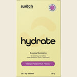 Single Mango Passionfruit Switch Nutrition Hydrate electrolyte sachet next to a glass of orange drink.