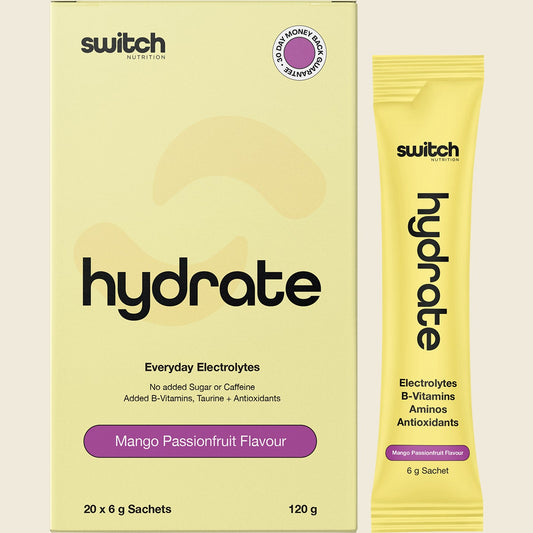 Switch Nutrition Hydrate Mango Passionfruit 20-pack box and single sachet with a glass of orange electrolyte drink.
