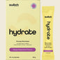 Switch Nutrition Hydrate Mango Passionfruit 20-pack box and single sachet with a glass of orange electrolyte drink.