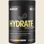 600g tub of Switch Nutrition Hydrate Perform Raspberry Lemonade electrolytes and carbs powder on a white background.