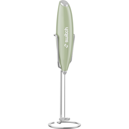 Sage green Switch Nutrition Whiz Stick electric handheld mixer with a silver whisk on a white background.